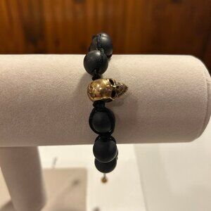 Gold skull bracelet.